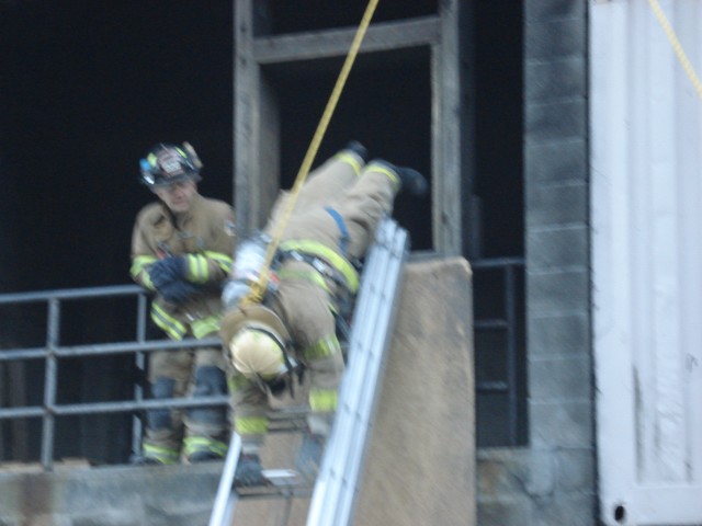 Lieutenant Gembecki climbs down the ladder head first
